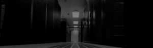 A hallway with many doors and lights in it