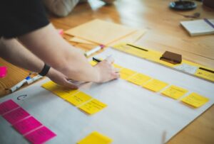 A person is working on a project with sticky notes.