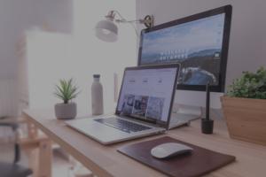 A laptop and mouse on top of a desk.