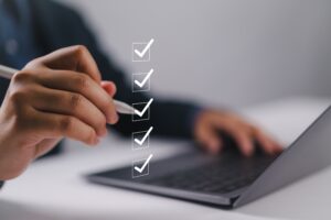 Person checking off items on a digital list.