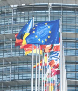 EU flags waving outside a building.
