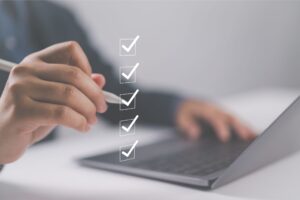 Person checking off items on a digital checklist.