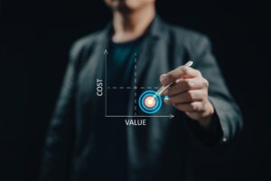 Here's an alt tag for the image: Person drawing value vs. cost graph.